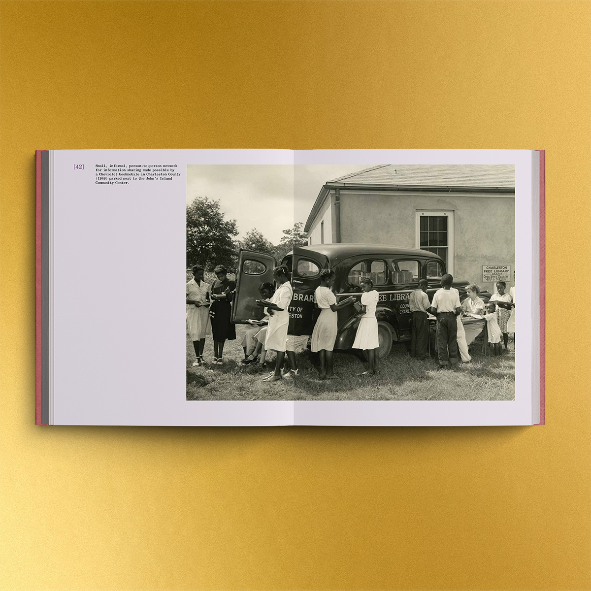 yellow background. book spread open to display a black and white photograph spanning both pages of a bookmobile in Charleston County from 1946. a white middle-aged woman sits at a table. she is surrounded by 10 African American girls, boys, and young women, many of whom are holding books and reading.